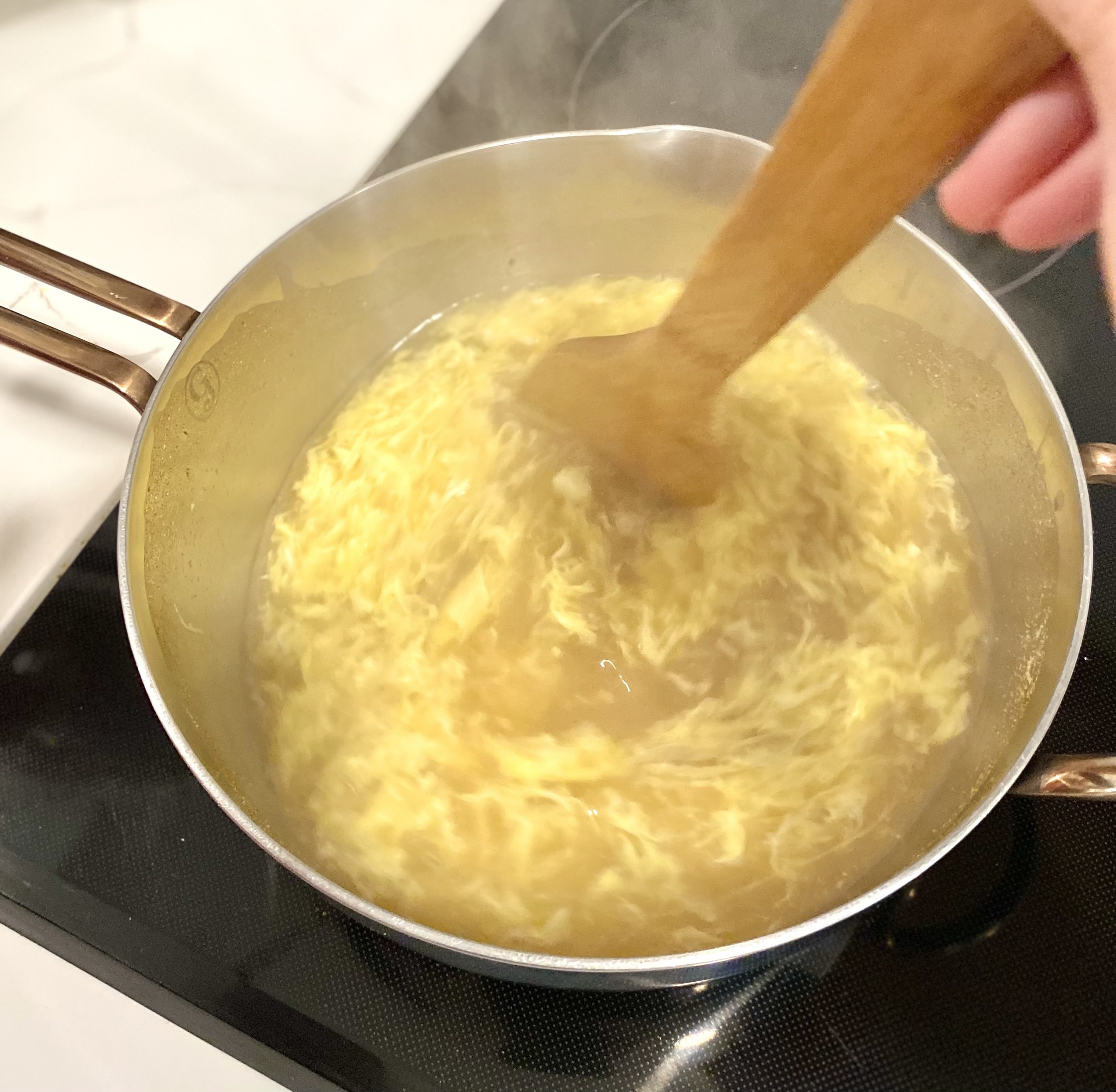 stirring egg in a circular motion in egg drop soup