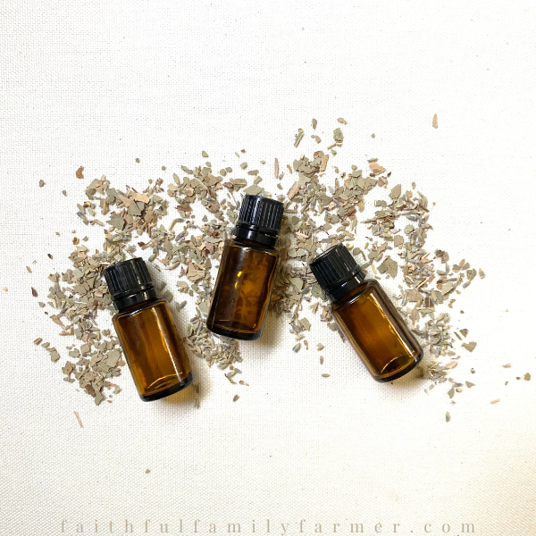 essential oils and herbs on a white surface